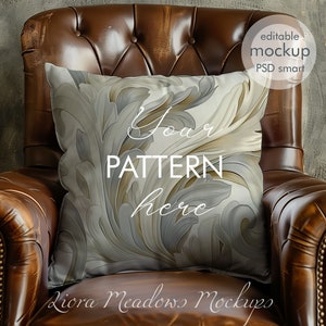 May include: A brown leather armchair with a decorative pillow featuring a white and gray floral pattern. The pillow has the text "Your Pattern Here" on it.
