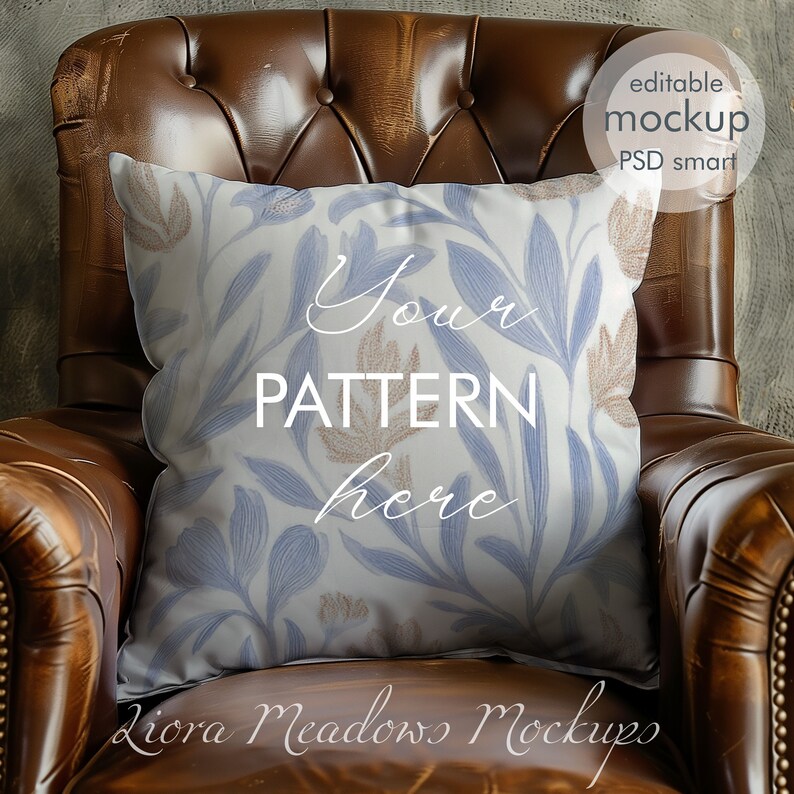May include: A white pillow with a blue and brown floral pattern sits on a brown leather armchair. The pillow has the text "Your pattern here" printed on it.