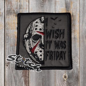 May include: A black square patch featuring a hockey mask design with red accents and the text "I WISH IT WAS FRIDAY." The patch has a stitched border and a logo that says "Stitch with Attitude."