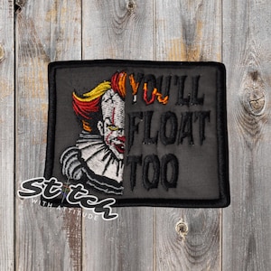 May include: Black rectangular patch featuring a half-face image of a clown with red, yellow, and white details. The text "YOU'LL FLOAT TOO" is embroidered in black. The patch has a black border and the words "Stitch with Attitude" are in the lower left corner.