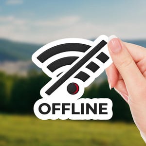 May include: A white sticker with a black and red "OFFLINE" design. The sticker features a wifi symbol crossed out with a diagonal line. The word "OFFLINE" is printed in bold, black letters below the symbol.