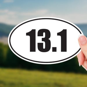 May include: White oval sticker with black text that reads "13.1".
