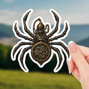May include: A steampunk-style sticker featuring a mechanical spider with intricate gear details. The spider has a metallic body with bronze and black accents, and a clock-like face. The sticker is held against a blurred outdoor background.