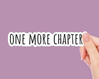 May include: A white sticker with black text that reads "ONE MORE CHAPTER" held by a hand against a purple background.