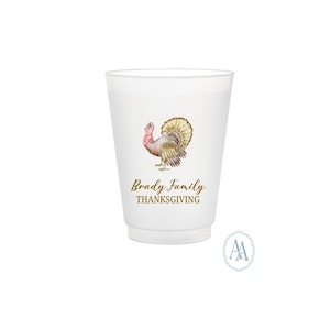 May include: White plastic cup with a watercolor illustration of a turkey and the text "Brady Family THANKSGIVING" in gold lettering. The cup has a slightly frosted appearance and is suitable for beverages.