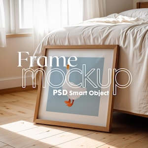 May include: A wooden frame mockup with a light blue background and a white goose illustration. The text "PSD Smart Object" is visible in the bottom left corner of the frame.