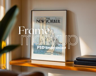 May include: A framed print of a vintage New Yorker magazine cover featuring a cityscape with a sailboat in the foreground. The cover is dated 18th July, 1943, and the price is £1.25. The frame is silver and has a simple design.