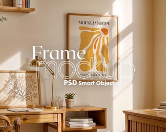 May include: A framed abstract art print with a yellow and orange design hangs on a white wall above a wooden desk. The print is titled "Mockup Shop" and includes the text "Frame Mockup PSD Smart Object".