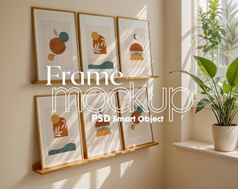May include: A set of six framed abstract art prints with geometric shapes and organic elements in shades of brown, orange, yellow, blue, and green. The prints are arranged on a wooden shelf against a white wall. The text "Frame Mockup PSD Smart Object" is visible in the image.