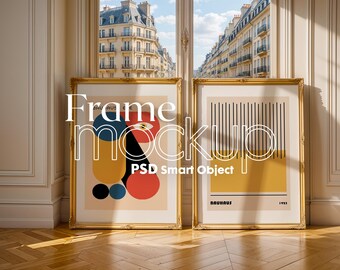 May include: Two gold framed posters hanging on a wall. The poster on the left features a colorful abstract design with the text "Frame Mockup PSD Smart Object". The poster on the right features a black and white striped design with the text "Bauhaus 1923".