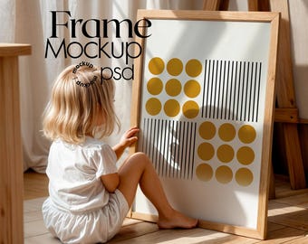May include: A framed art print with a geometric design of gold circles and black vertical lines. The frame is light wood. The words "Frame Mockup psd" are printed on the top left of the image.
