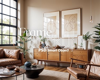 May include: Two framed abstract art prints with a brown background and white lines, hanging on a beige wall above a wooden cabinet with a brown leather armchair in front of it.