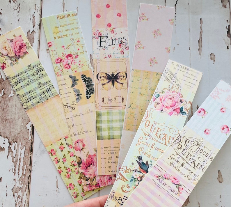 Puede incluir: Un conjunto de 10 marcap&aacute;ginas de estilo vintage con motivos florales, texto y un dise&ntilde;o de mariposa. Los marcap&aacute;ginas est&aacute;n impresos en papel con un acabado texturizado y tienen una gama de colores rosa claro y crema.