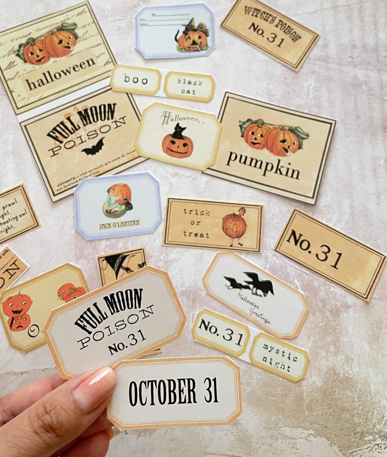 May include: A collection of vintage Halloween themed stickers with various designs, including pumpkins, bats, owls, and the text "Full Moon Poison" and "No. 31".