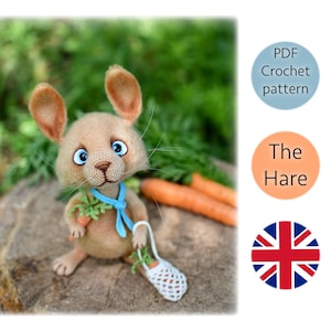 May include: A crocheted hare amigurumi toy holding a carrot and a small white bag. The hare is brown with blue eyes and a blue scarf. The toy is sitting on a brown rock with green grass in the background. The image also includes text that says "PDF Crochet pattern" and "The Hare".