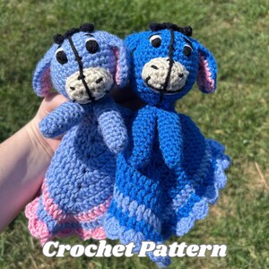 May include: Two handmade crochet Eeyore plushies in shades of blue and purple. The plushies have black eyes, black hair, and tan faces. The text "Crochet Pattern" is displayed at the bottom of the image.