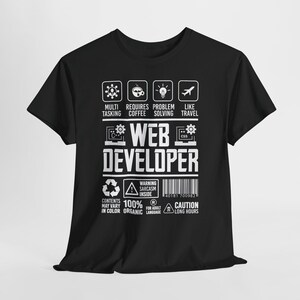 May include: Black t-shirt with white text and icons. The text reads "WEB DEVELOPER" with icons representing multi-tasking, coffee, problem-solving, and travel. Additional text includes "Warning: Sarcasm Inside" and "Caution: Long Hours."