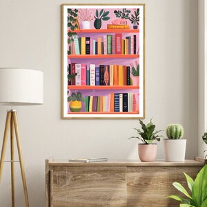 May include: A pink bookshelf with multiple shelves filled with colorful books and potted plants. The bookshelf is against a white wall.