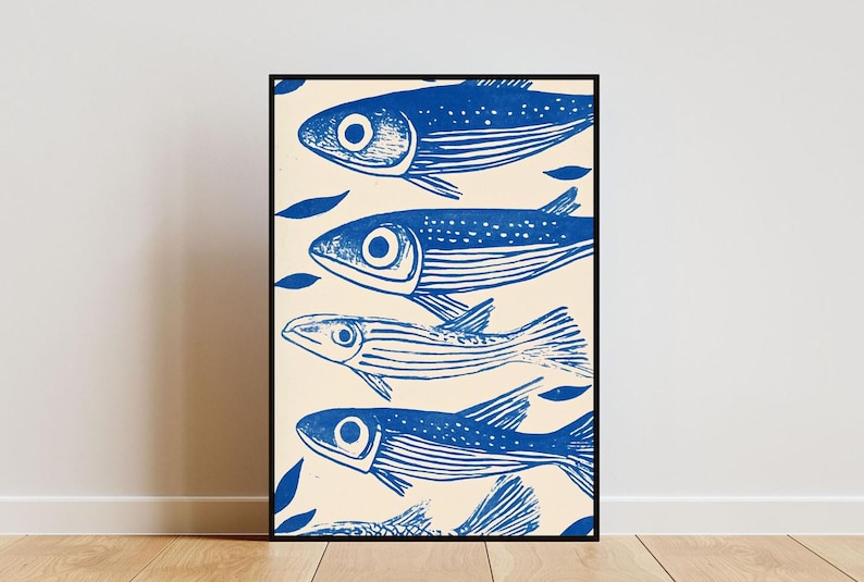 May include: A framed print of a blue and white illustration of four fish swimming in a row. The fish are stylized and have a simple design. The background is a light cream color.