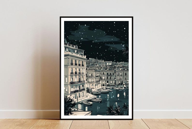May include: Black framed art print depicting a nighttime cityscape with buildings, boats, and a starry sky. The illustration is in shades of gray and white, with lights illuminating the buildings and water. The artwork is displayed on a white wall.