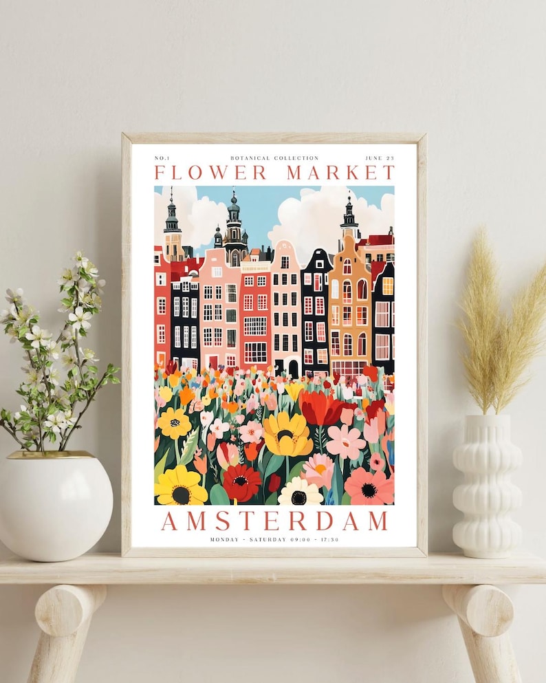 May include: A colorful poster with a whimsical illustration of a flower market in Amsterdam. The poster features a row of colorful buildings with red roofs and a field of flowers in the foreground. The text on the poster reads "Flower Market" and "Amsterdam".