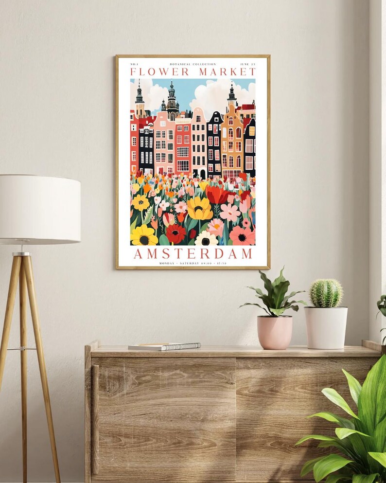 May include: A colorful poster with the text "Flower Market" and "Amsterdam" in red. The poster features a cityscape with colorful buildings and a field of flowers in the foreground.