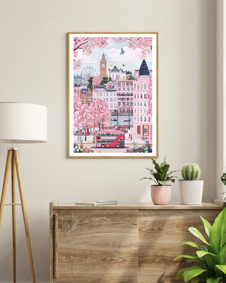 May include: A framed illustration of a London cityscape with a red double-decker bus, a Ferris wheel, and pink cherry blossoms.