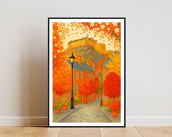 May include: A framed art print showing an autumnal street scene. A cobbled road leads to a castle on a hill, flanked by orange trees and buildings. The artwork uses warm colours, including orange, yellow, and red, creating a cosy and inviting atmosphere.