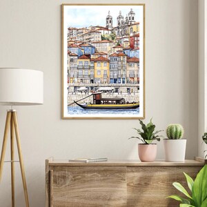May include: A watercolor painting of a cityscape with colorful buildings and a boat in the foreground. The buildings are clustered together and have a variety of architectural styles. The boat is a traditional Portuguese boat with a yellow hull and a brown roof.