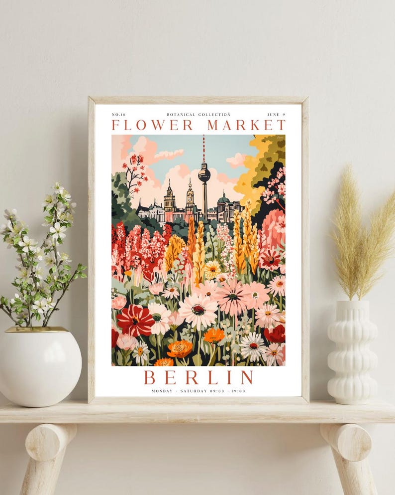 May include: A vintage-style poster advertising a flower market in Berlin, Germany. The poster features a colourful illustration of a flower garden with the Berlin TV Tower in the background. The text on the poster reads "Flower Market, Berlin, Monday - Saturday 09:00 - 19:00".