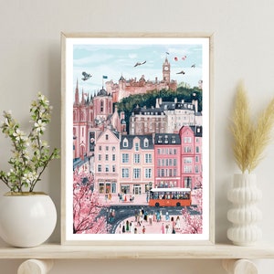 May include: A watercolor painting of a city scene with pink buildings, a red bus, and a castle in the background. The city is bustling with people and there are cherry blossom trees in the foreground.
