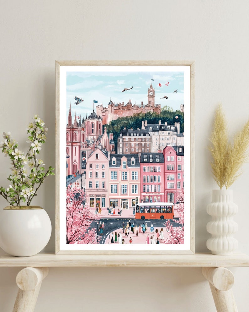 May include: A watercolor painting of a city scene with pink buildings, a red bus, and a castle in the background. The city is bustling with people and there are cherry blossom trees in the foreground.