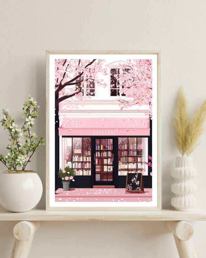May include: A pink storefront with a sign that reads "BOOKSHOP" surrounded by a cherry blossom tree. The storefront has large windows displaying bookshelves filled with books. The sidewalk is covered in pink cherry blossom petals.