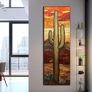 May include: A vertical artwork depicting a desert scene with a large saguaro cactus. The artwork features warm tones of orange, red, and brown, with a detailed rendering of the cactus and surrounding landscape. The artwork is displayed in a modern interior.