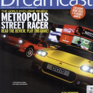 Pode incluir: A revista oficial Dreamcast número 12 de outubro de 2000 com Metropolis Street Racer na capa. A capa exibe um carro esportivo amarelo e um carro esportivo vermelho com faróis brilhantes, junto com texto sobre discos de demonstração.