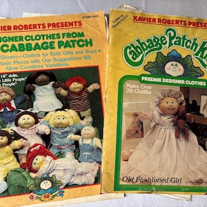 May include: Two vintage Cabbage Patch Kids sewing pattern envelopes. The left envelope features Xavier Roberts Presents Designer Clothes From The Cabbage Patch with images of dolls in various outfits. The right envelope shows Preemie Designer Clothes.