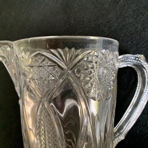 EAPG pressed glass pitcher – Starburst and fan pattern - pedestal base pitcher