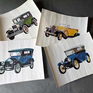 May include: Four vintage car prints. The cars are in various colors, including green, yellow, and blue. Each print features a different classic car design, showcasing the style of automobiles from a bygone era. The prints are on off-white paper.