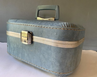 Turquoise train case with blue interior