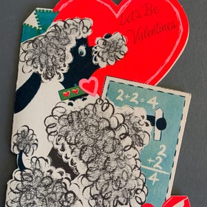 May include: A vintage Valentine's Day card featuring a black and white poodle holding a red heart and a blue and white card with the equation 2+2=4. The card has a red heart with the text "Let's Be Valentines" on it.