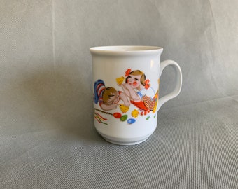 Colorful porcelain mug featuring children in a cute scene with chicks and eggs