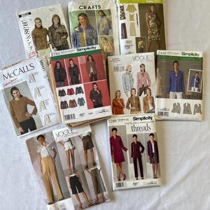 May include: A collection of vintage sewing patterns featuring women's fashion designs. The patterns are from brands like McCall's, Vogue, and Simplicity. The patterns showcase jackets, dresses, and other garments. The covers display images of the finished clothing.