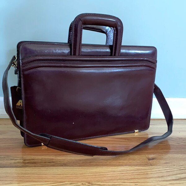 Handsome leather attache case - oxblood leather - gold toned hardware - 3 roomy sections with space for everything