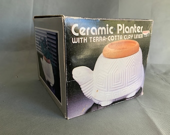 Turtle planter with a terracotta insert - new in box - with some chips out of the terracotta insert