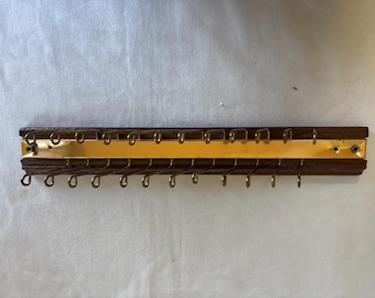 Mid-century wood and brass wall-mounted tie rack - 24 tie pegs