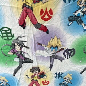 May include: A fabric print featuring multiple anime-style characters in dynamic poses against a background of yellow, blue, and green circular shapes. The design includes red, green, and black symbols, along with characters in red, white, and purple outfits.