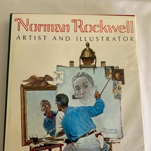 Puede incluir: Una portada de libro con una ilustración de Norman Rockwell pintando un autorretrato. La portada tiene el título "Norman Rockwell Artista e Ilustrador" en texto rojo.