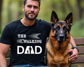 May include: Black t-shirt with the text "THE WALKING DAD" in white. The graphic shows a silhouette of a person walking a dog. A German Shepherd dog is sitting next to the person.