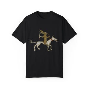 May include: A black t-shirt with a graphic print of a brown rabbit riding a white dog. The rabbit is holding a small object in its hand.