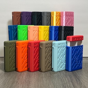 May include: A collection of colorful rectangular cases with textured diagonal line patterns. The cases are in various colors, including green, orange, red, brown, blue, and yellow. The cases are arranged on a wooden surface.